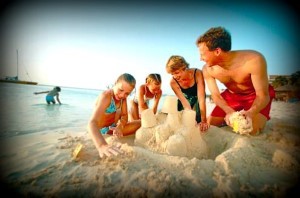 Image of family building a sand castle at the beach